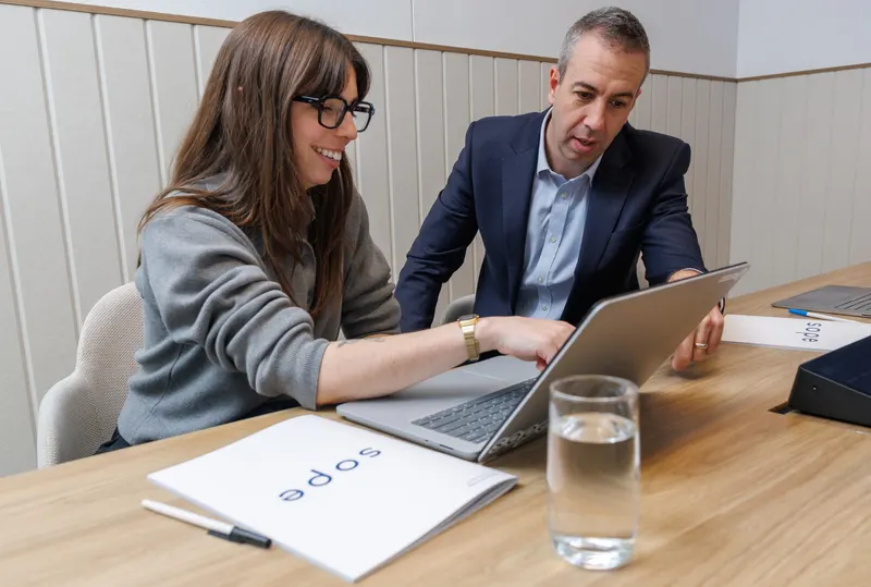 Two Sope consultants working through a project together on a laptop