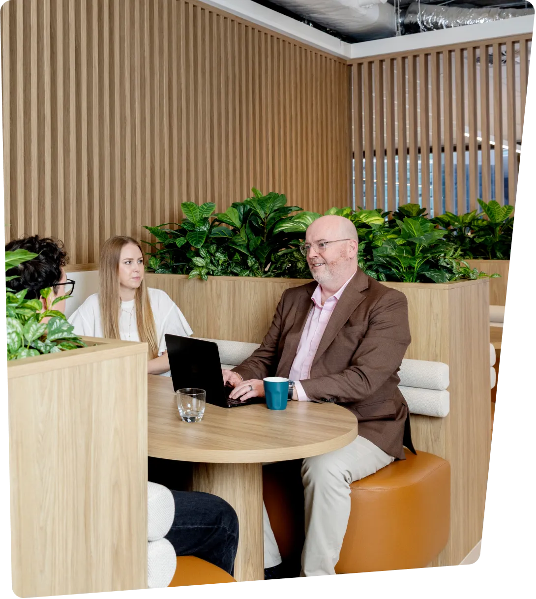 A man and woman looking at laptop screen