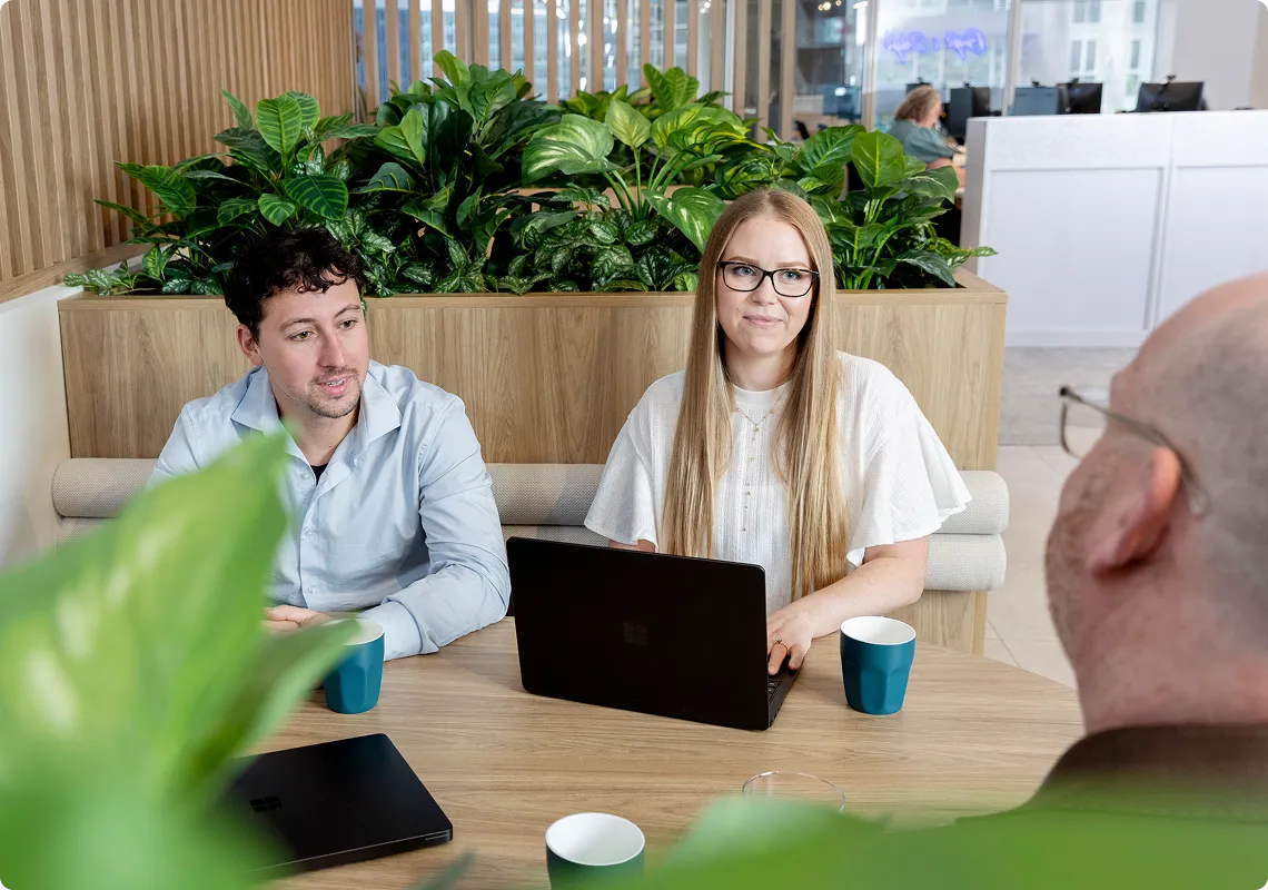 A man and woman looking at laptop screen